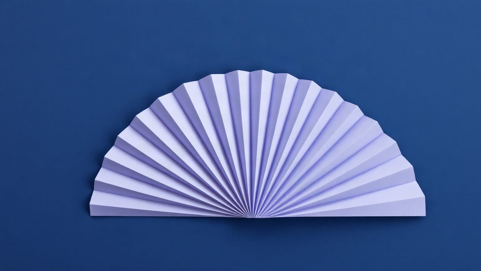 Cut-paper illustration: a folded paper fan opening into a wide semicircle.
