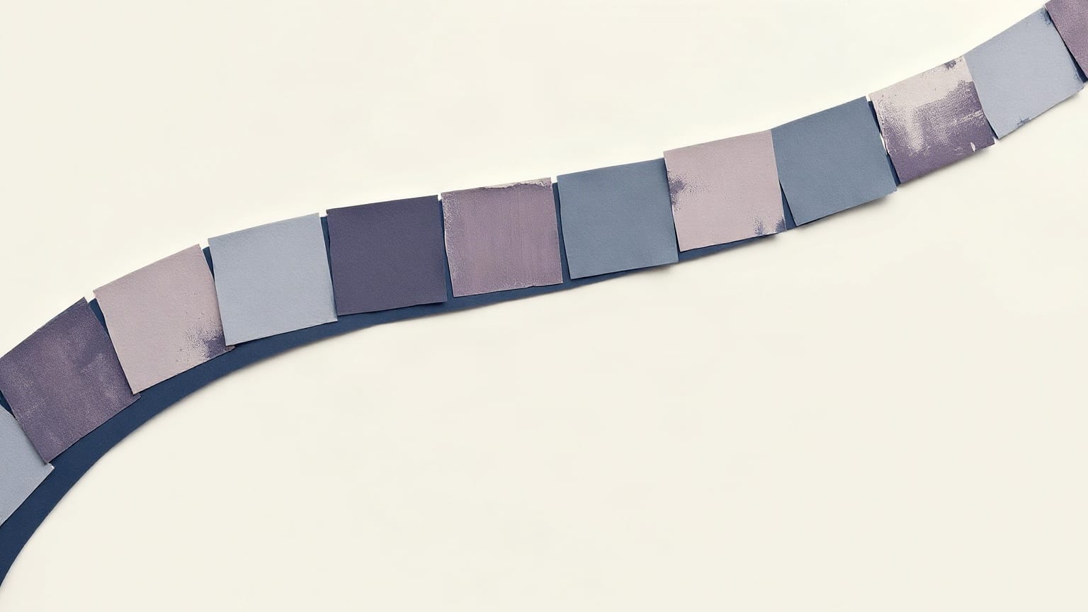 A wide arc of small paper rectangles in muted violets and greys sweeping across a bone-white ground